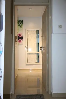 a hallway with a door and a window in a room at Agdal 1 in Rabat