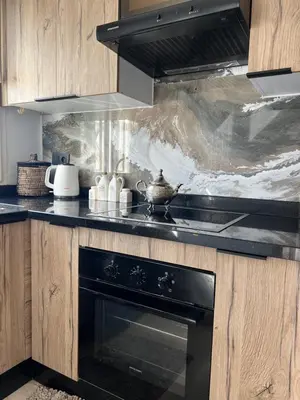 a kitchen with a black stove top oven at Maarif , Cosy 2 Chambres, Parking wifi Netflix Gratuit in Casablanca