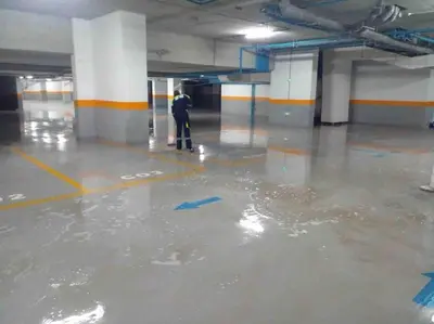 a man is standing in a flooded parking lot at Luxury flat at Casa Finance city in Casablanca