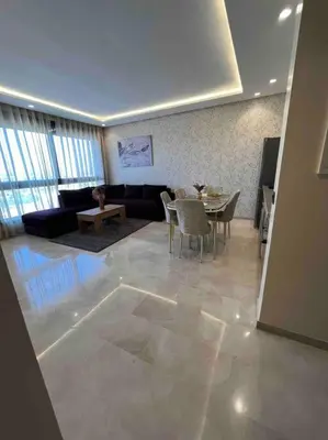 a living room with a couch and a table at Luxury flat at Casa Finance city in Casablanca