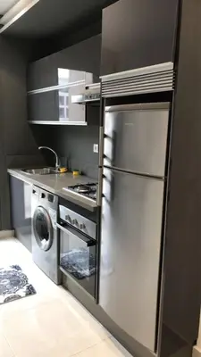 a kitchen with a stainless steel refrigerator and a stove at Charming apartment at Maarif in Casablanca