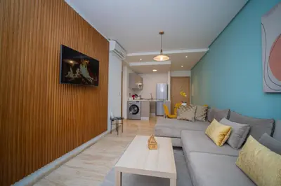 a living room with a couch and a table at studio Maarif à 3min à pied du stade med V in Casablanca