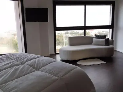 a white bed and a couch in a room with windows at Luxury Villa Jack Beach Resort Ocean Oasis View Panoramic in Casablanca