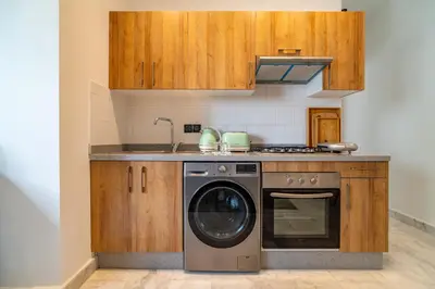 a kitchen with a stove and a washing machine at AeroHarmony in Nouaceur