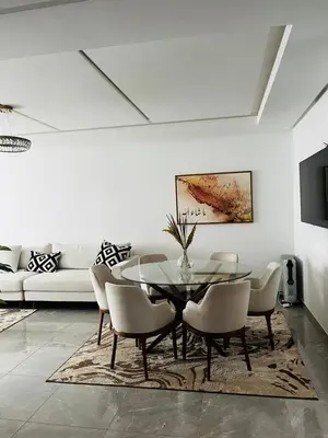 a dining room with a glass table and chairs at Harhoura Modern Flat in Temara