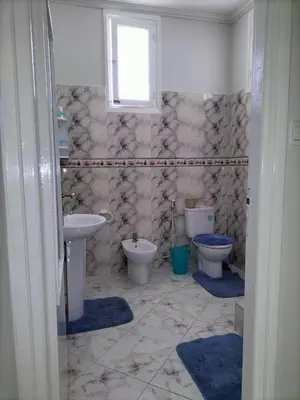 a bathroom with two toilets and a sink and a window at Villa Pierrette Casablanca in Casablanca