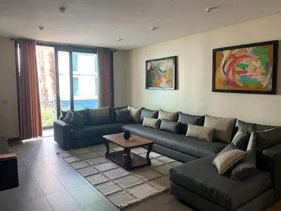 a living room with a couch and a table at Ocean View Apartment - Anfa Place - in Casablanca
