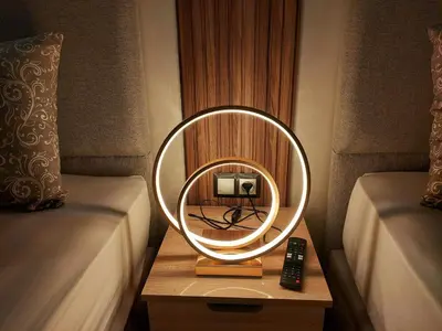 a round mirror on a table next to two beds at modern apartment opposite to HASSAN2 MOSQUE & FAIR international casablanca , near downtwn, with side SEA view with sports machines with free underground GARAGE prohibited for unmarried couples of Arab original apartment too QUIET in Casablanca