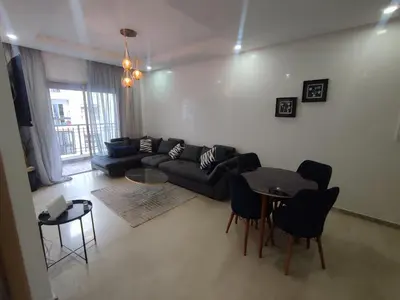a living room with a couch and a table at Studio La gironde in Casablanca