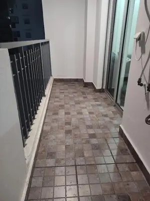 a balcony with a tiled floor and glass doors at Studio La gironde in Casablanca