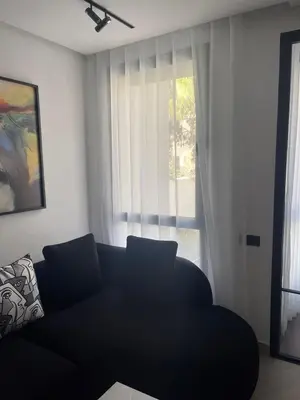 a living room with a couch and a window at Magic Appartement Luxury Gauthier 10 in Casablanca