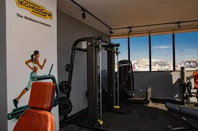 a gym with a painting of a woman on the wall at Appartement neuf 2 chambres avec salle de sport in Casablanca