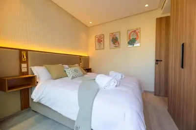 a bedroom with a bed with towels on it at Appartement luxueux et lumineux Maarif Casablanca in Casablanca