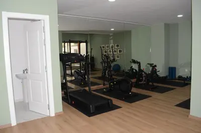 a gym with several treadmills and exercise bikes in a room at Luxury apartment fully furnished in Casablanca