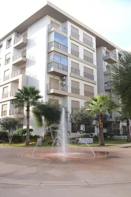 a fountain in front of a large building at Luxury apartment fully furnished in Casablanca
