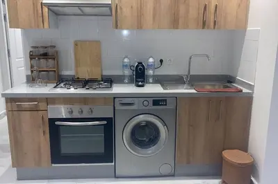 a kitchen with a washing machine and a sink at Luxury apartment fully furnished in Casablanca
