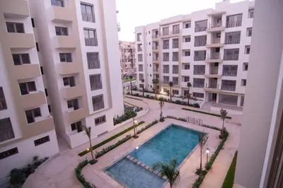 an overhead view of a swimming pool between two buildings at New Luxury apartment 5 min Casablanca Mohammed V Airport in Casablanca