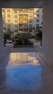 a swimming pool in the middle of a building at New Luxury apartment 5 min Casablanca Mohammed V Airport in Casablanca