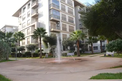 a fountain in front of a apartment building at New Luxury apartment 5 min Casablanca Mohammed V Airport in Casablanca