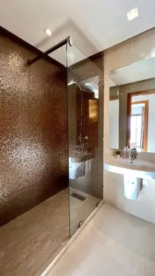 a bathroom with a shower and a sink and a mirror at The building of Terrazas 34 - By AppartAli in Casablanca