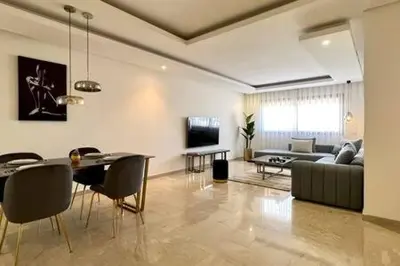 a living room with a couch and a table and chairs at Business Travelers and Families - 3 Bedrooms in Casablanca