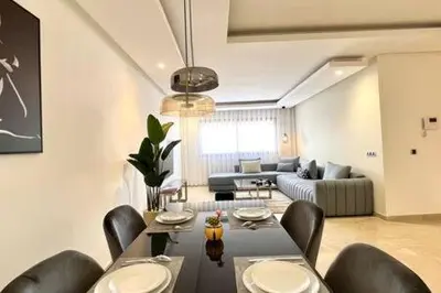 a living room with a table and chairs and a couch at Business Travelers and Families - 3 Bedrooms in Casablanca