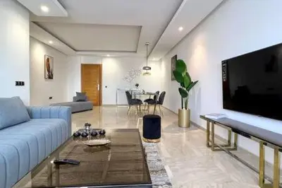 a living room with a couch and a flat screen tv at Business Travelers and Families - 3 Bedrooms in Casablanca