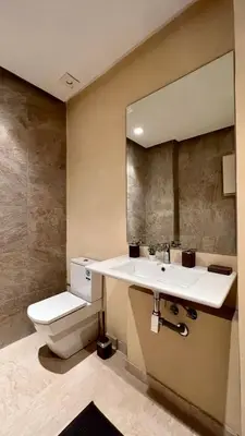 a bathroom with a sink and a toilet and a mirror at La Vida est Magnifique - 3 Chambres in Casablanca
