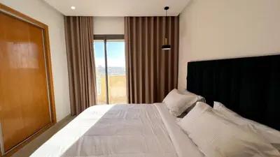 a bedroom with a large bed with a large window at Marvelous Center Spot - 3 Bedrooms in Casablanca