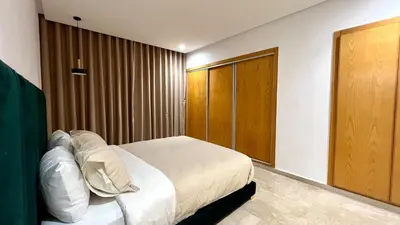 a bedroom with a bed and a wooden door at Marvelous Center Spot - 3 Bedrooms in Casablanca
