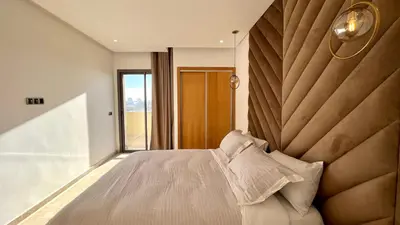 a bedroom with a large bed with a large headboard at Family 3 Bedrooms- By AppartAli in Casablanca