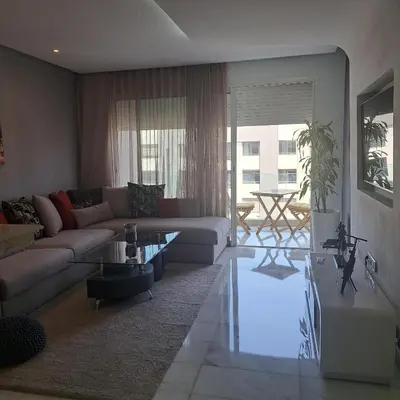 a living room with a couch and a table at Studio ALMASSIRA in Casablanca