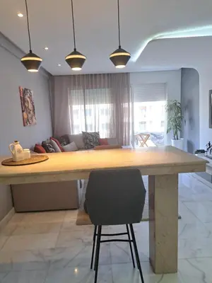 a kitchen with a large wooden table in a room at Studio ALMASSIRA in Casablanca