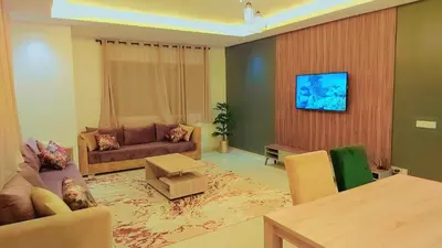 a living room with a couch and a table at Appartement Perla - Costa Bouznika in Bouznika
