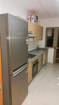 a kitchen with a large stainless steel refrigerator at Appartement Perla - Costa Bouznika in Bouznika