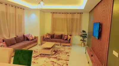 a living room with two couches and a table at Appartement Perla - Costa Bouznika in Bouznika