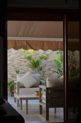 a room with a couch and a table with plants at Nassali - Luxurious Beachfront Villa with Private Pool in Casablanca