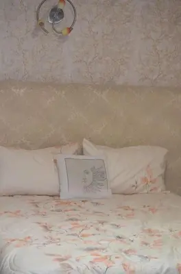 a bed with two pillows and a picture on it at Nassali - Luxurious Beachfront Villa with Private Pool in Casablanca