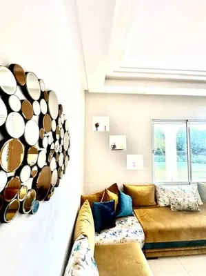 a living room with a couch and cups on the wall at Oasis de Sérénité en Bord de Mer in Casablanca