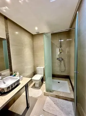 a bathroom with a shower and a toilet and a sink at Oasis de Sérénité en Bord de Mer in Casablanca