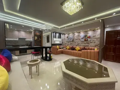 a large living room with couches and a fireplace at Appartement spacieux et moderne in Casablanca