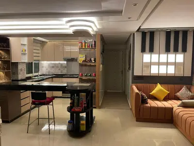 a kitchen and living room with a couch and a table at Appartement spacieux et moderne in Casablanca