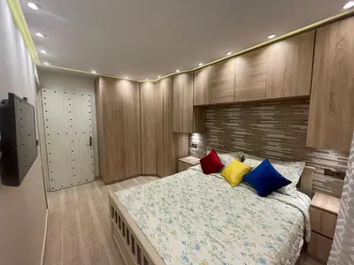 a bedroom with a large bed with colorful pillows at Appartement spacieux et moderne in Casablanca