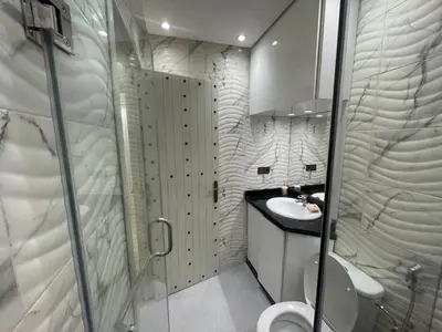 a bathroom with a toilet and a sink and a shower at Appartement spacieux et moderne in Casablanca