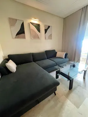 a living room with a couch and a table at Résidence Ryad Albahr Herhoura in Temara