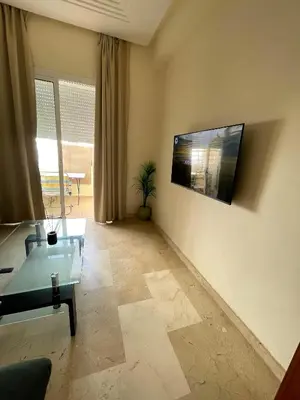 a living room with a couch and a table at Résidence Ryad Albahr Herhoura in Temara