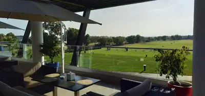 a view of a golf course from a window at Bahia Golf Beach Bouznika appart in Bouznika