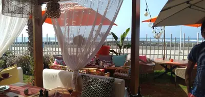 a patio with a table and chairs and an umbrella at Bahia Golf Beach Bouznika appart in Bouznika