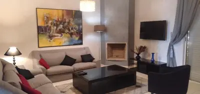 a living room with a couch and a coffee table at Bahia Golf Beach Bouznika appart in Bouznika