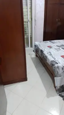 a bedroom with a bed sitting on a tiled floor at tranquil harmony in Casablanca